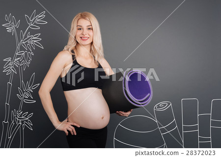 Positive pregnant woman holsding sport rug Positive pregnant woman holsding sport rug 28372023
