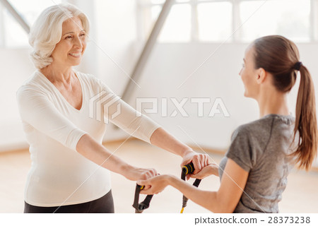 Happy aged woman holding a resistance band 28373238