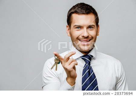 Handsome stylish businessman on grey background 28373694