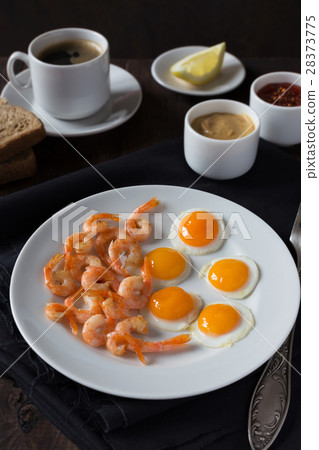 Fried quail eggs and shrimps on a white plate Fried quail eggs and shrimps on a white plate 28373775