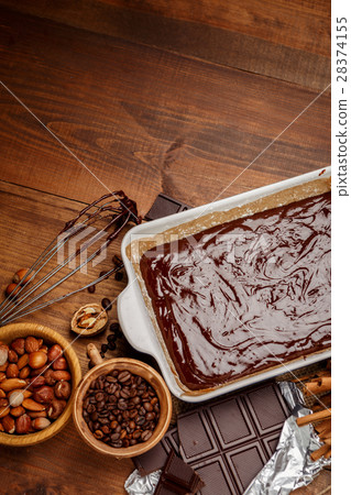 Baking chocolate cake in rural or rustic kitchen. Baking chocolate cake in rural or rustic kitchen. 28374155