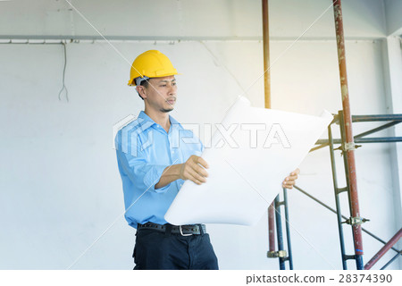 construction engineer hand holding blueprint 28374390