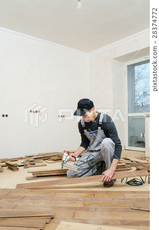 Installing a wooden floor. Installing a wooden floor. 28374772