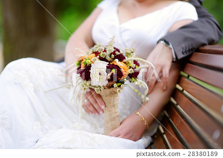 Bride holding a beautiful wedding bouquet 28380189