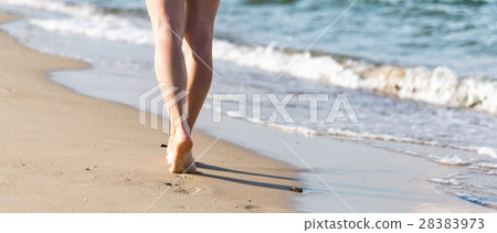 Beach travel - woman walking Beach travel - woman walking 28383973