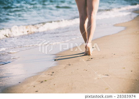 Beach travel - woman walking 28383974