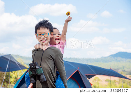 Young brother and sister playing together outdoor Young brother and sister playing together outdoor 28384527