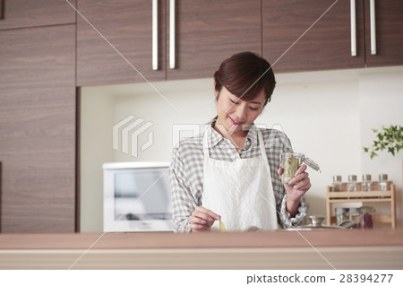 A woman standing in the kitchen 28394277