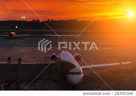 Plane at the airport during sunset 28395104