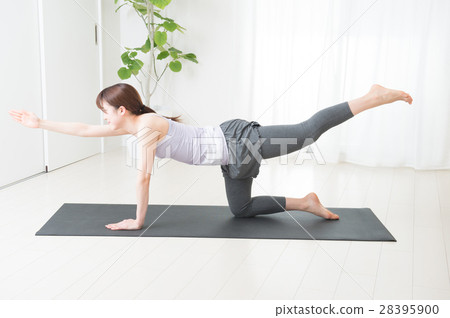 A young lad yoga in a bright room 28395900