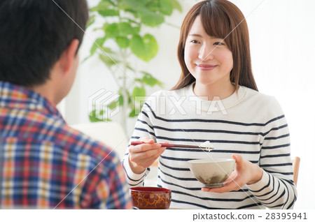 A young couple who eats breakfast at the table opposite A young couple who eats breakfast at the table opposite 28395941