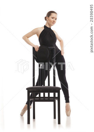 Pretty young ballerina posing with chair. Isolated Pretty young ballerina posing with chair. Isolated 28398495
