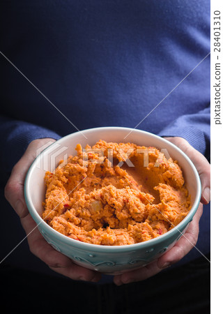 Bowl with hummus on the hands vertical Bowl with hummus on the hands vertical 28401310