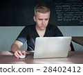 student is preparing for a lecture in classroom 28402412
