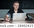 student is preparing for a lecture in classroom 28402415