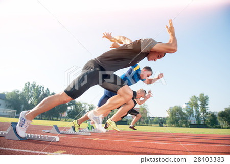 Runners preparing for race at starting blocks 28403383