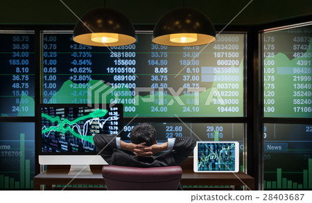 Back side of sitting businessman who is looking at big screen and desktop computer with tablet showing the trading graph of stock market exchange graph background, Business trading and finance concept 28403687