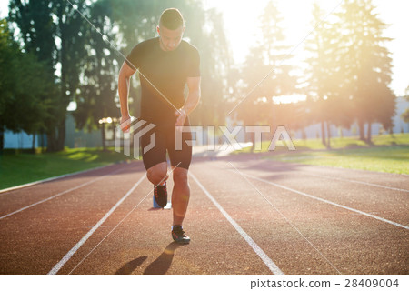 Sprinter leaving starting blocks on the running Sprinter leaving starting blocks on the running 28409004