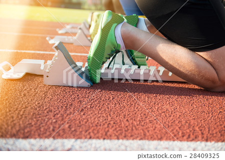 Feet on starting block ready for a spring start. Feet on starting block ready for a spring start. 28409325