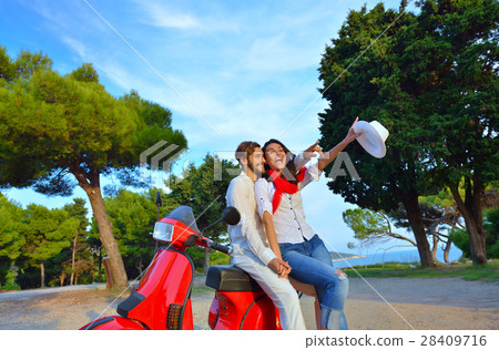 Young biker couple on the country road against the Young biker couple on the country road against the 28409716