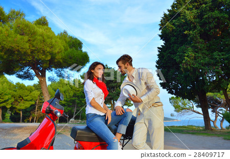 Young biker couple on the country road against the 28409717