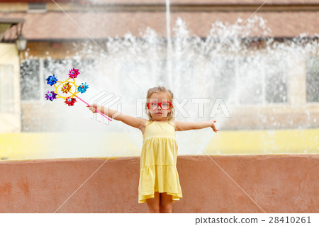 Little girl holding pinwheel Little girl holding pinwheel 28410261