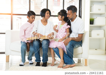 happy indian family eating pizza at home 28411161