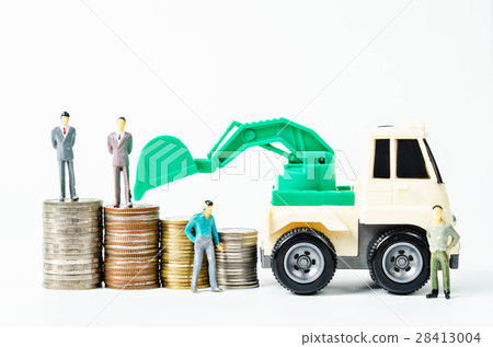 Stack of coins money and backhoe loader toy. 28413004