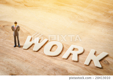 Wooden work letter with miniature businessman 28413010