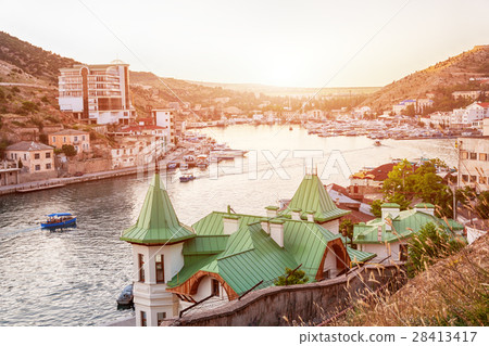 Sailing boats and yachts anchored in calm bay at 28413417