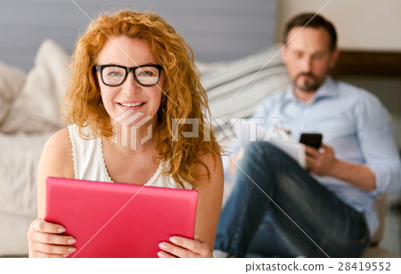 Cheerful woman sitting and smiling at home 28419552