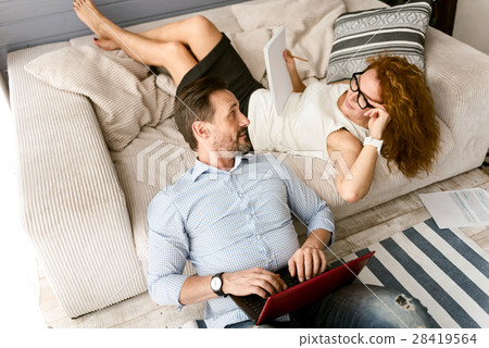 Energetic husband and wife working at home 28419564