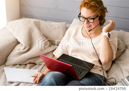 Positive charming woman working at home Positive charming woman working at home 28419700