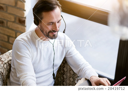 Handsome bearded man using modern devices in the 28419712