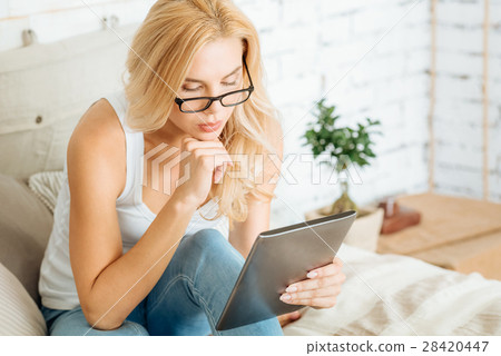 56. Concentrated woman using tablet in bed 56. Concentrated woman using tablet in bed 28420447