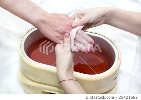 Process paraffin treatment of female hands in beau 28421669