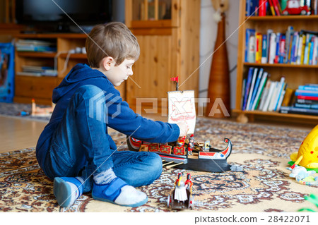 Little blond preschool kid boy playing with toy Little blond preschool kid boy playing with toy 28422071