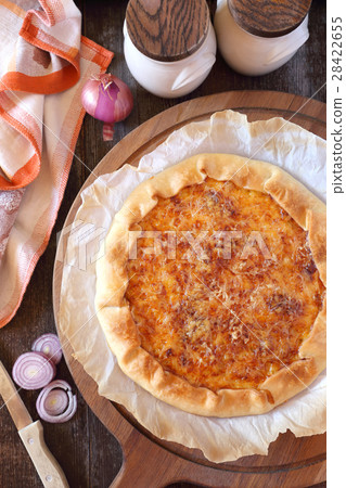 Onion cheese pie on wooden chopping board 28422655