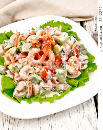 Salad with shrimp and tomato on lettuce in plate 28422764