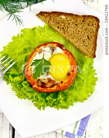 Scrambled eggs in tomato on board top 28422766