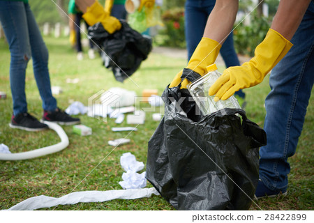 Man in rubber gloves collecting rubbish Man in rubber gloves collecting rubbish 28422899
