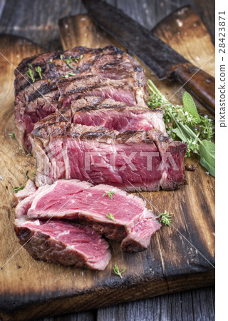 Barbecue Rib Eye Steak sliced on Cutting Board Barbecue Rib Eye Steak sliced on Cutting Board 28423871