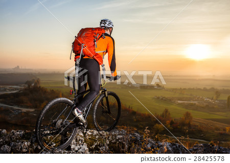 A cyclist with a backpack on a background of blue A cyclist with a backpack on a background of blue 28425578