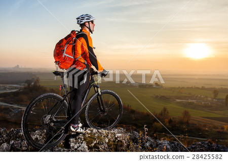 A cyclist with a backpack on a background of blue A cyclist with a backpack on a background of blue 28425582