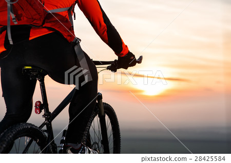 Man on mountain bike rides on the trail on a Man on mountain bike rides on the trail on a 28425584