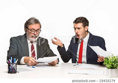 The two colleagues working together at office on The two colleagues working together at office on 28428174