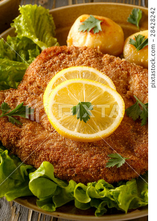 Wiener schnitzel with potatoes and salad. Wiener schnitzel with potatoes and salad. 28428242