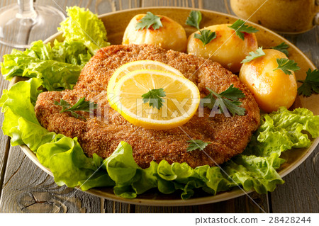 Wiener schnitzel with potatoes and salad. Wiener schnitzel with potatoes and salad. 28428244