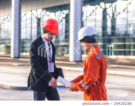 young boss and worker discussing project young boss and worker discussing project 28428286