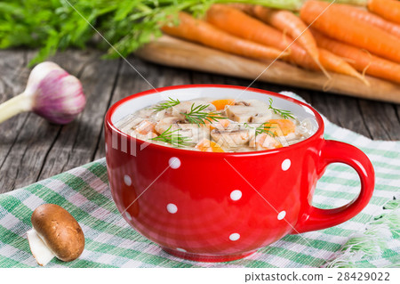 spring garlic carrot soup with mushrooms, closeup 28429022